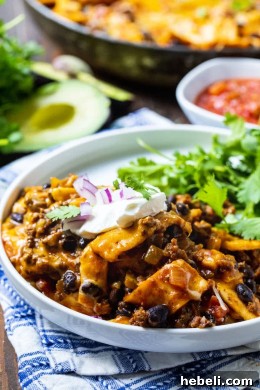 One-Pot Beef Burrito Skillet 4 A serving of Beef Burrito Skillet on a white plate with fresh cilantro garnish.