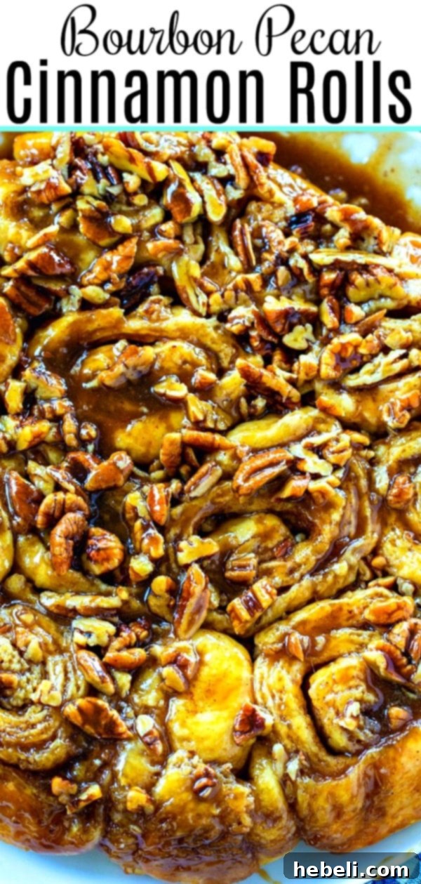 A vibrant close-up of baked Bourbon Pecan Cinnamon Rolls, drenched in sticky caramel.