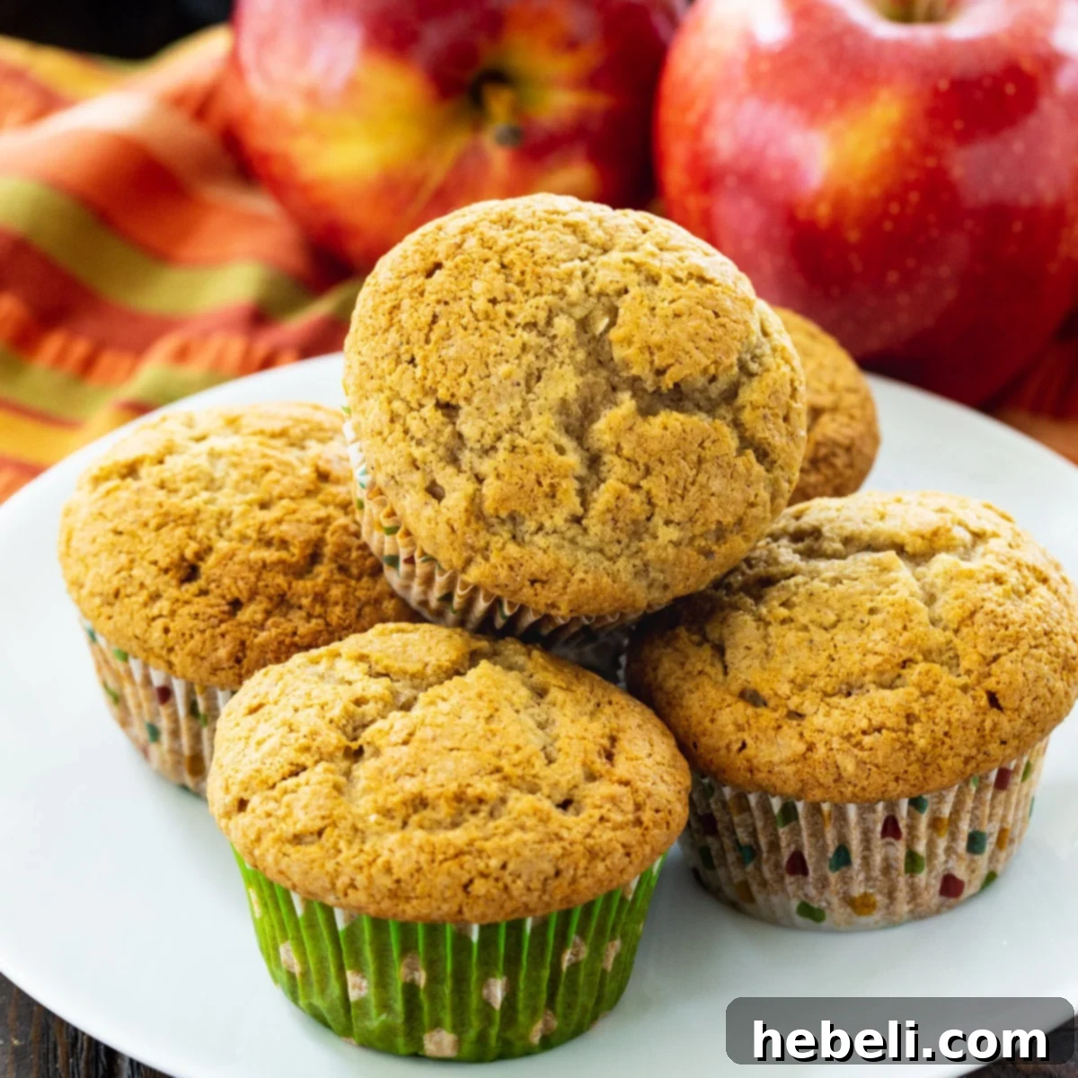 Delicious Apple Butter Muffins artfully arranged on a rustic plate, ready to be enjoyed as a perfect fall treat.