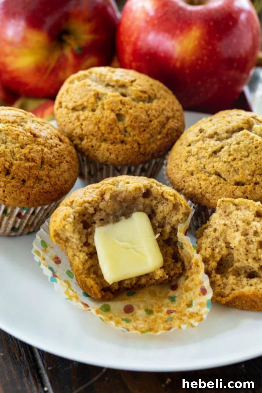 A perfectly sliced Apple Butter Muffin with a dollop of butter on top, showcasing its soft interior and inviting texture.