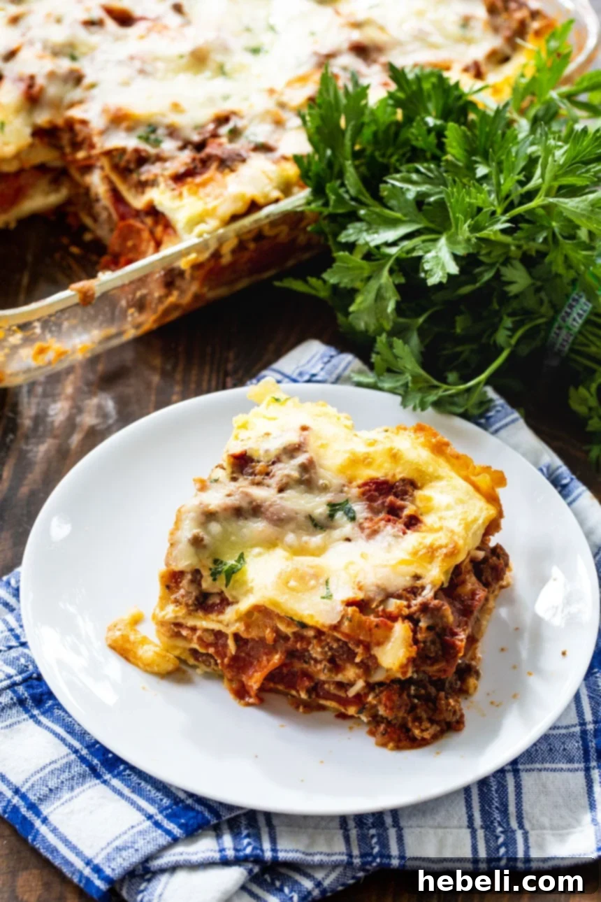 Velvety Cream Cheese Lasagna 4 A close-up view of a slice of Cream Cheese Lasagna, garnished with fresh parsley, highlighting its rich layers.