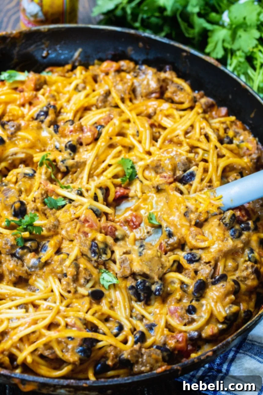 Tex-Mex Noodle Delight 3 Taco Spaghetti simmering in a large skillet, showing the creamy, cheesy texture.
