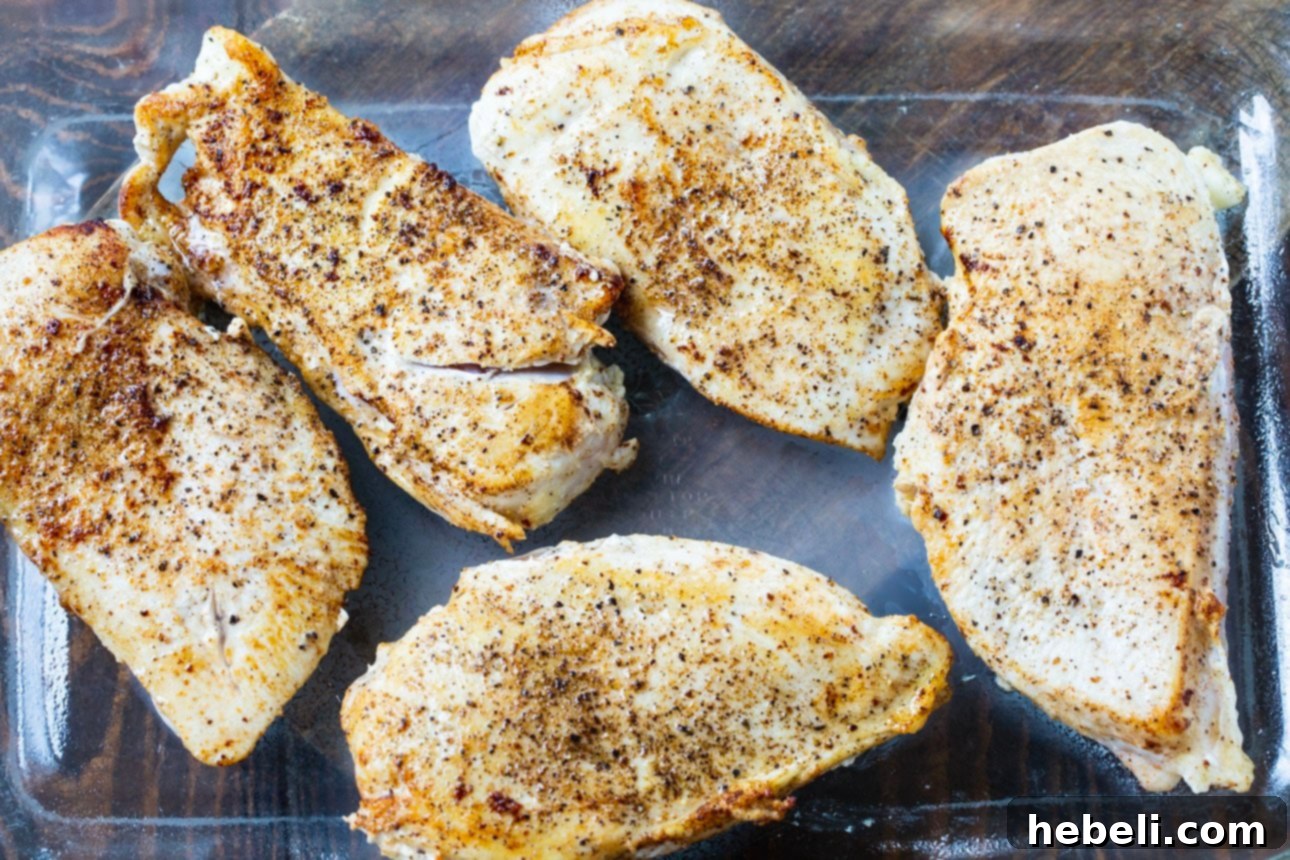 Maple Bacon Chicken Melt 3 Raw chicken breasts seasoned and arranged in a baking dish, ready for the oven.