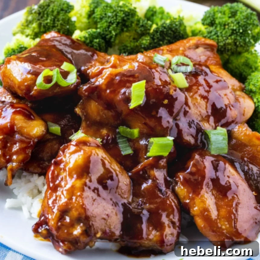 Chicken Teriyaki on a plate with broccoli and white rice.