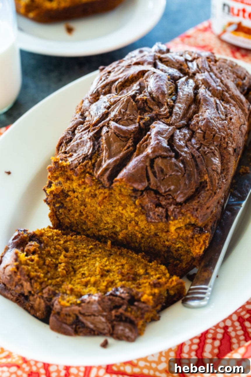 Nutella Swirl Pumpkin Bread 4 Close-up of a slice of Nutella Pumpkin Bread with rich Nutella streaks.