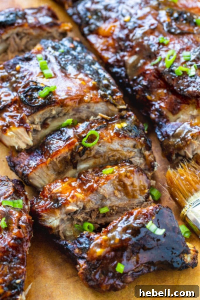 Sticky Sweet & Sour Ribs 4 A tantalizing close-up shot of the sticky, glazed Sweet and Sour Baby Back Ribs, showing their tender texture and rich sauce.