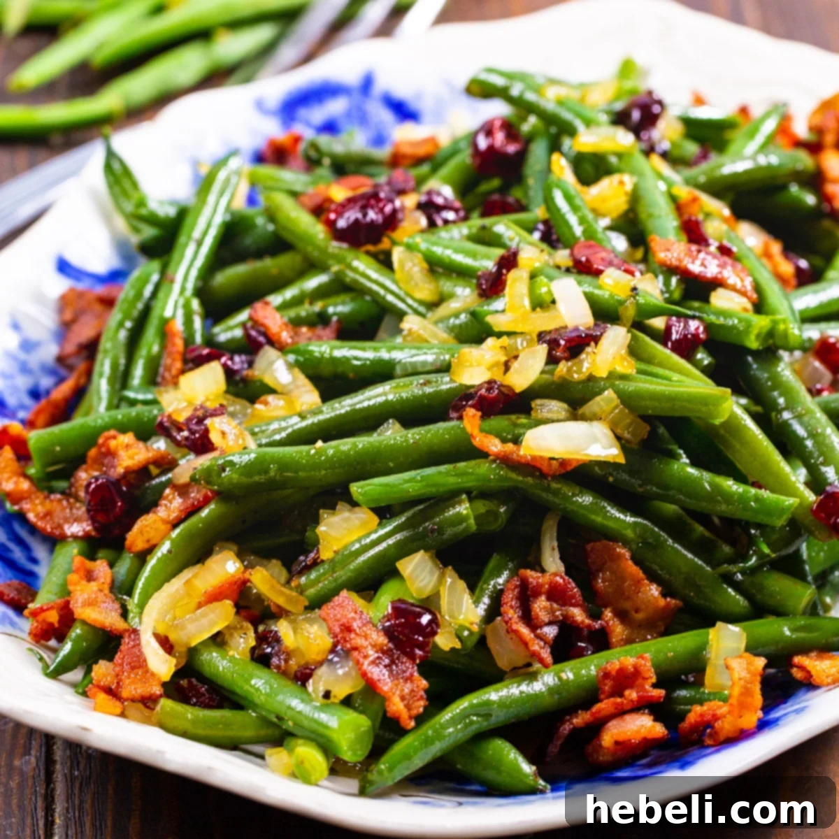 Maple-Glazed Green Beans topped with crumbled bacon on a serving platter, perfect for a holiday meal.