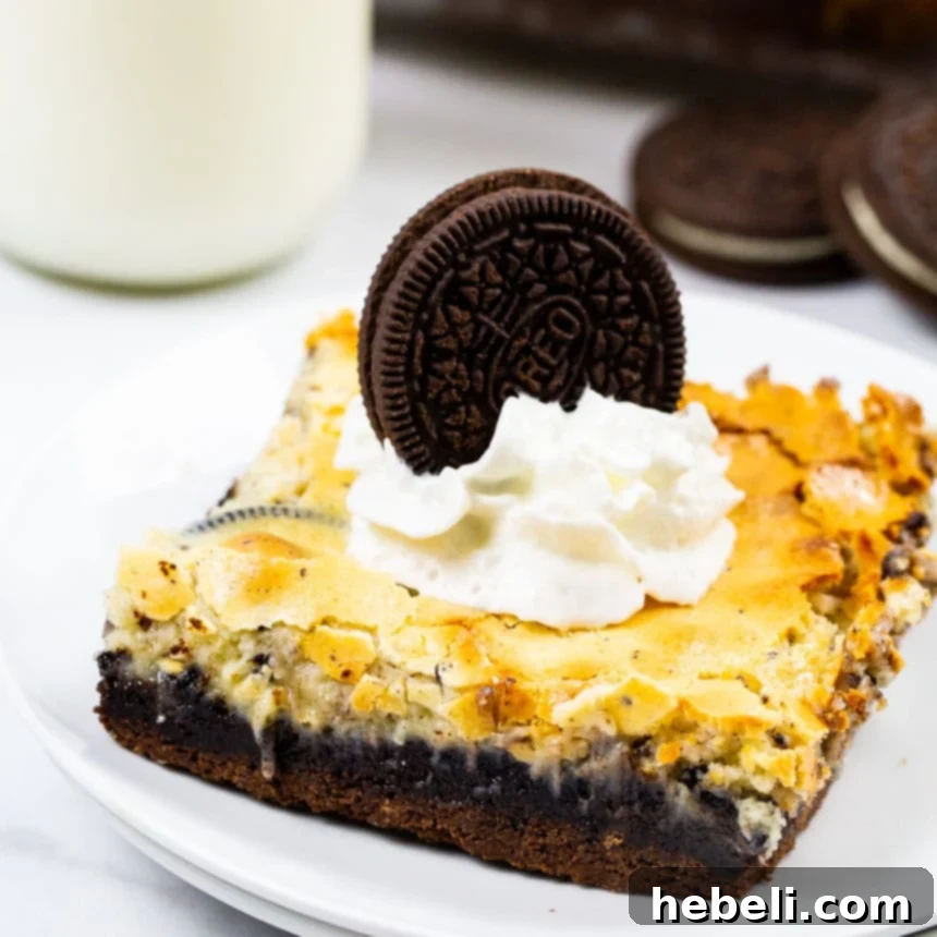 Velvet Swirl Cookie Bars 2 Decadent Cookies and Cream Gooey Bars topped with fresh whipped cream and an Oreo cookie, showcasing the rich chocolate cake and creamy filling.