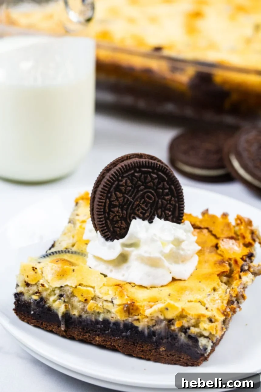 Velvet Swirl Cookie Bars 3 A single slice of Cookies and Cream Gooey Bar on a small plate, showing the distinct layers and crushed Oreo pieces.