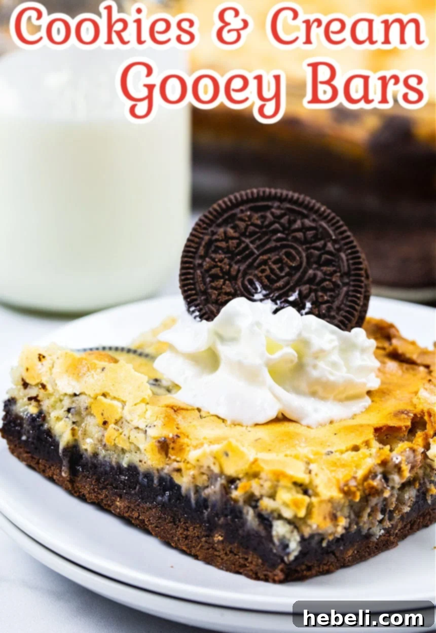 Velvet Swirl Cookie Bars 4 Close-up of a single Cookies and Cream Gooey Bar on a plate, garnished with whipped cream and an Oreo piece, emphasizing its rich texture.