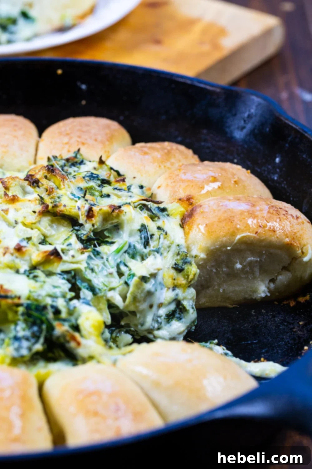 Spinach Artichoke Pull Apart Bread Ring 4 Spinach Artichoke Dip Bread Ring with several rolls pulled away from the center dip.