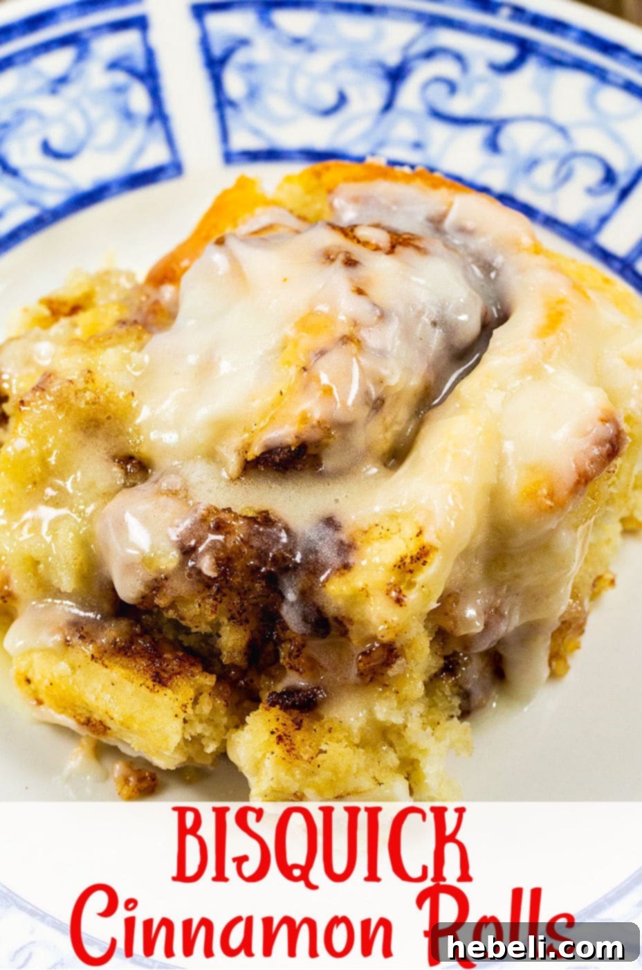 A top-down view of freshly baked, glazed Bisquick Cinnamon Rolls in a pan, with one roll carefully placed on a plate for serving.