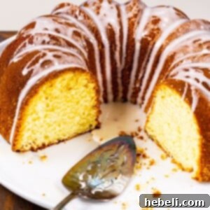 Three quarters of a Five Flavor Pound Cake on a serving platter.