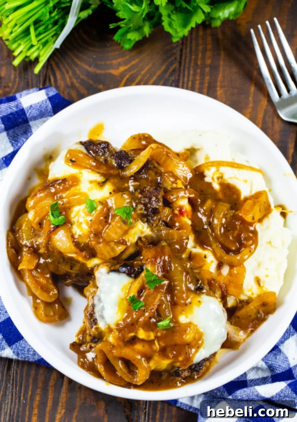 French Onion Smothered Salisbury Steak 4 A close-up of French Onion Salisbury Steak served over mashed potatoes, showcasing the rich gravy and melted cheese.