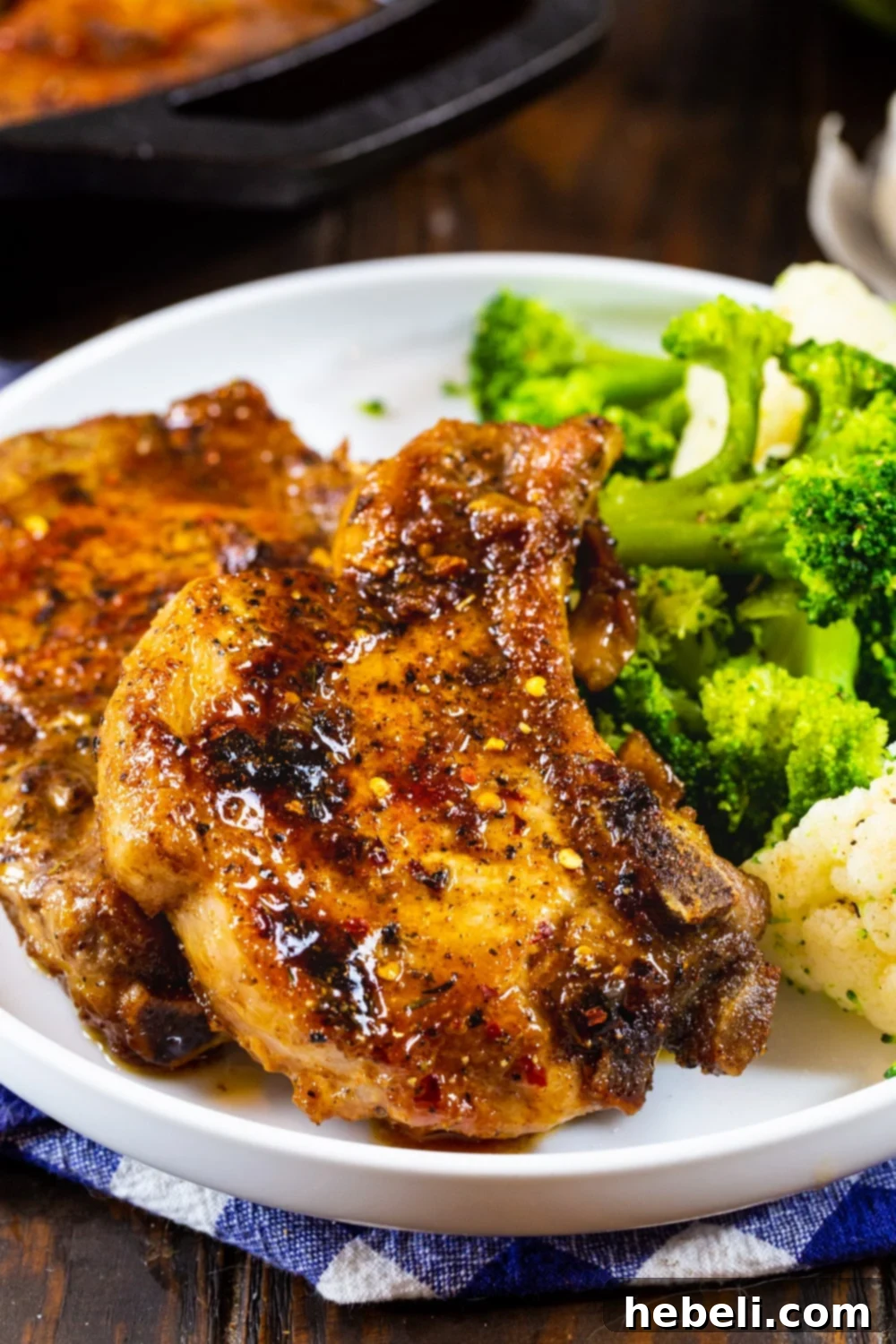 Sticky Brown Sugar Garlic Pork Chops 10 A serving of Brown Sugar Garlic Pork Chops presented beautifully on a plate with fresh broccoli, drizzled with the savory-sweet sauce.
