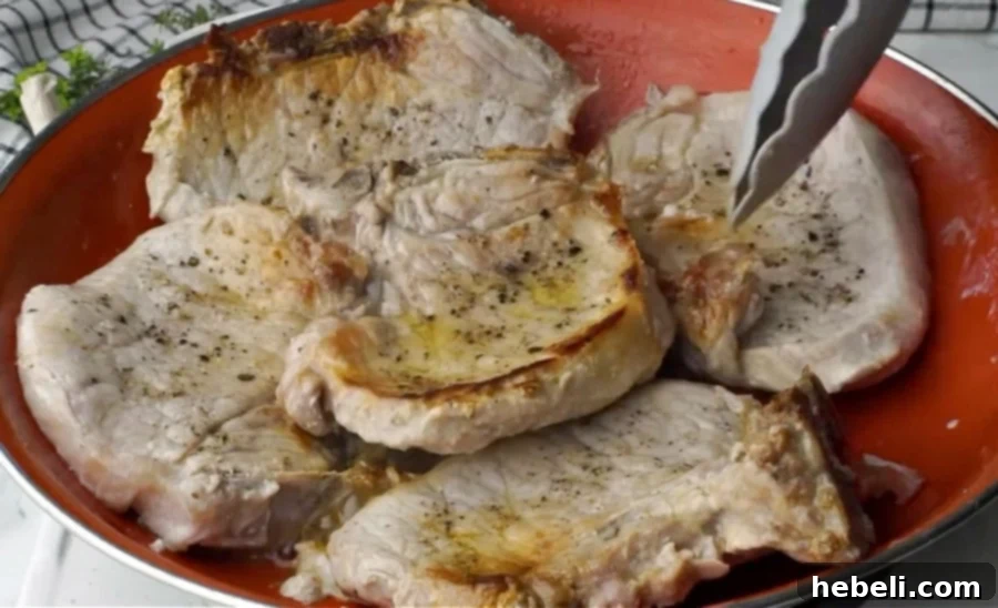 Sticky Brown Sugar Garlic Pork Chops 6 Searing the pork chops in a hot skillet to create a flavorful crust.