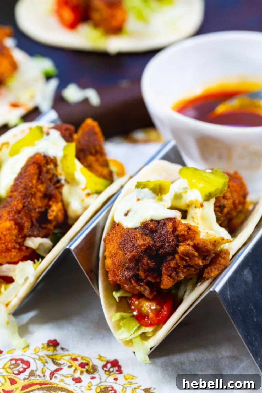 Blazing Nashville Chicken Tacos 3 Crispy fried chicken tacos drizzled with hot sauce and topped with fresh dill pickles.