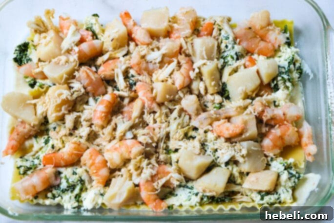 Seafood mixture with shrimp, scallops, and crab, layered on top of a ricotta and spinach mixture.