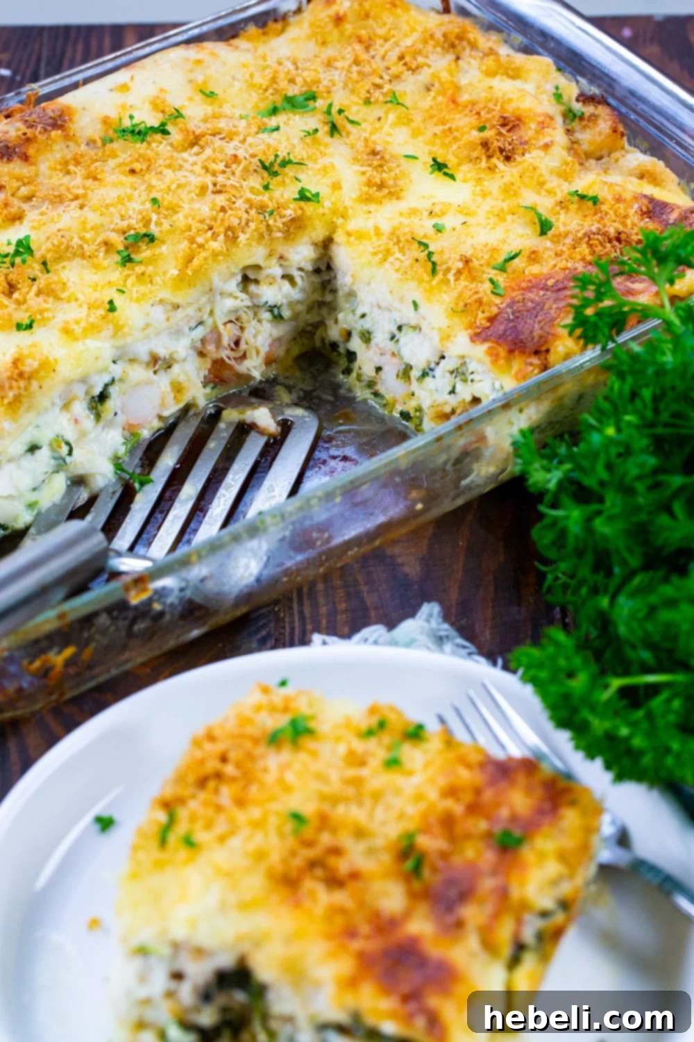 A large baking pan filled with White Seafood Lasagna, with several pieces already cut out, showing the delicious layers.