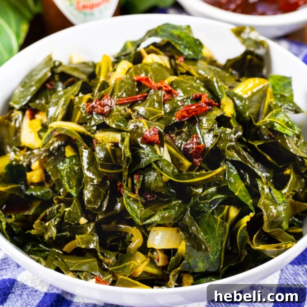 Smoky Chipotle Braised Greens 2 A serving of vibrantly green Chipotle Collard Greens in a pristine white bowl, showcasing their tender texture and inviting warmth.