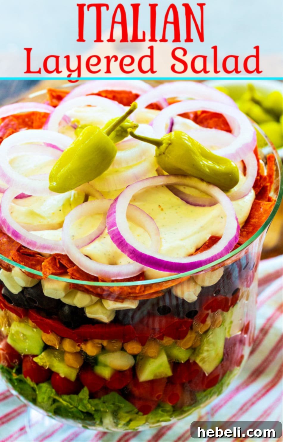 A vibrant Italian Layered Salad, showcasing its rich, creamy dressing and fresh ingredients, ready to be served.