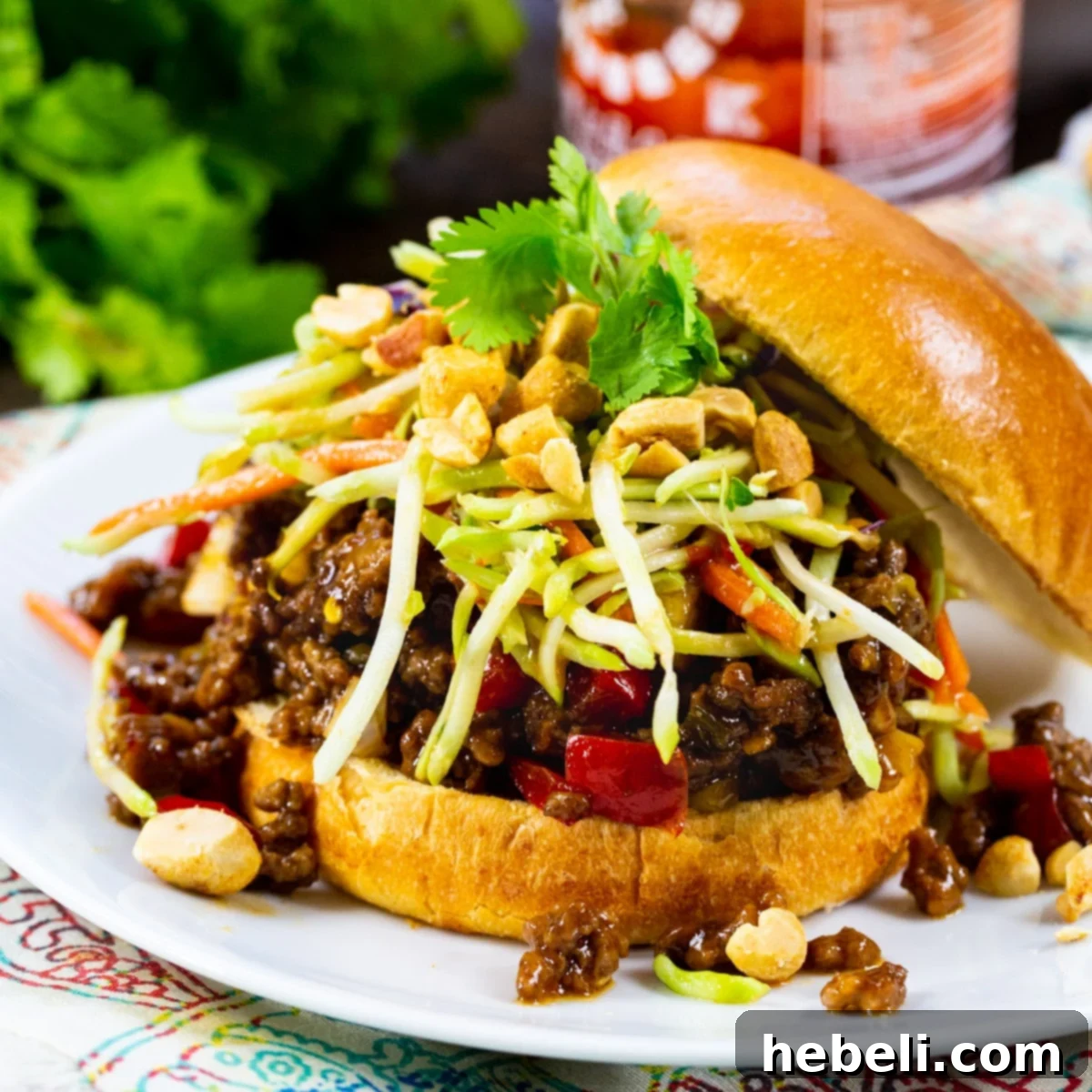 Delicious Kung Pao Sloppy Joes served on toasted buns with fresh broccoli slaw