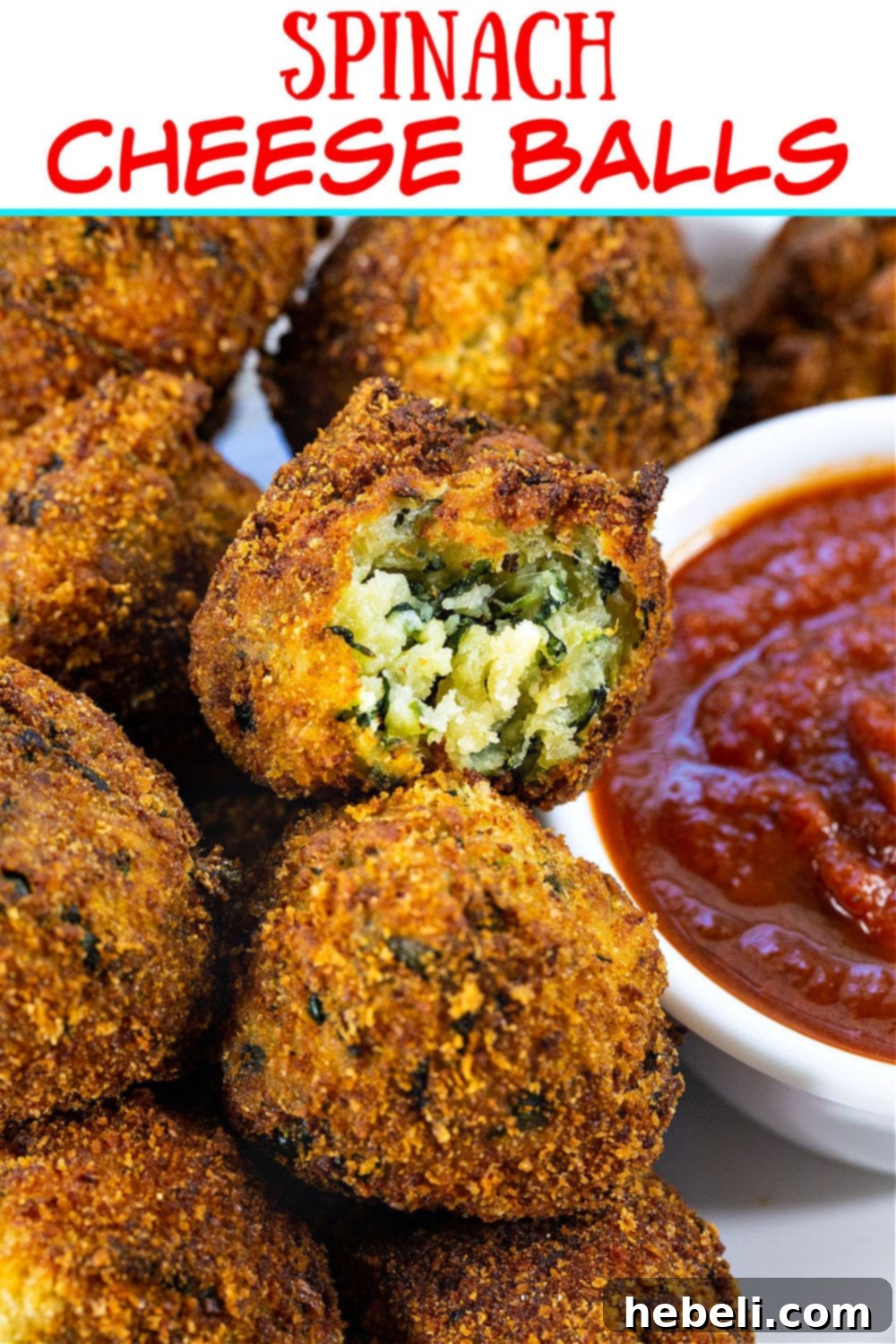 A spinach cheese ball cut in half, revealing the creamy green and white cheese filling inside and the perfectly crispy golden crust.