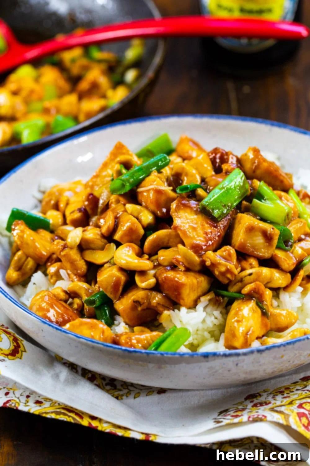 Classic Cashew Chicken 4 Another enticing view of the delicious Cashew Chicken served over fluffy white rice in a ceramic bowl, garnished with green onions and ready to eat.
