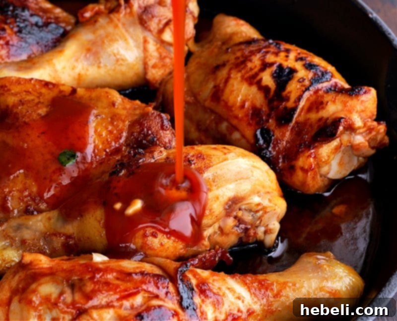 Caramelized Southern Chicken 5 Pouring the rich, flavorful glaze over the seared chicken nestled in the cast iron skillet.