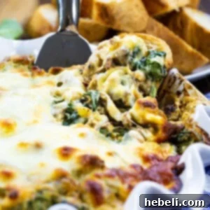 Tuscan Sausage and White Bean Dip in a white baking dish, prepared for serving.