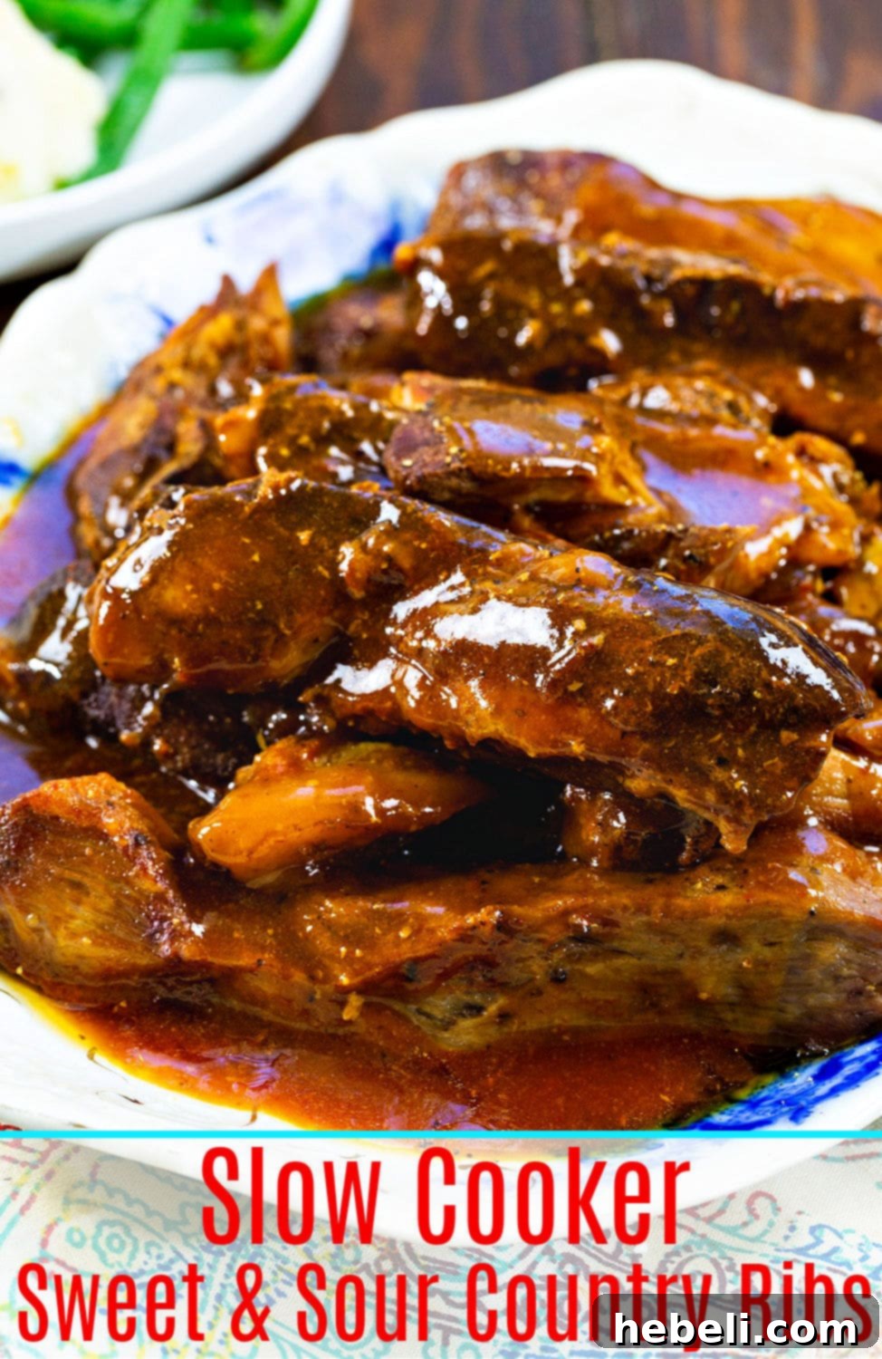 A close-up of Slow Cooker Sweet and Sour Country Ribs, showing the tender meat and glossy sauce.