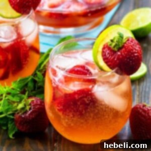 Strawberry Shortcake Sangria in a wine glass, capturing its vibrant color and inviting presentation.