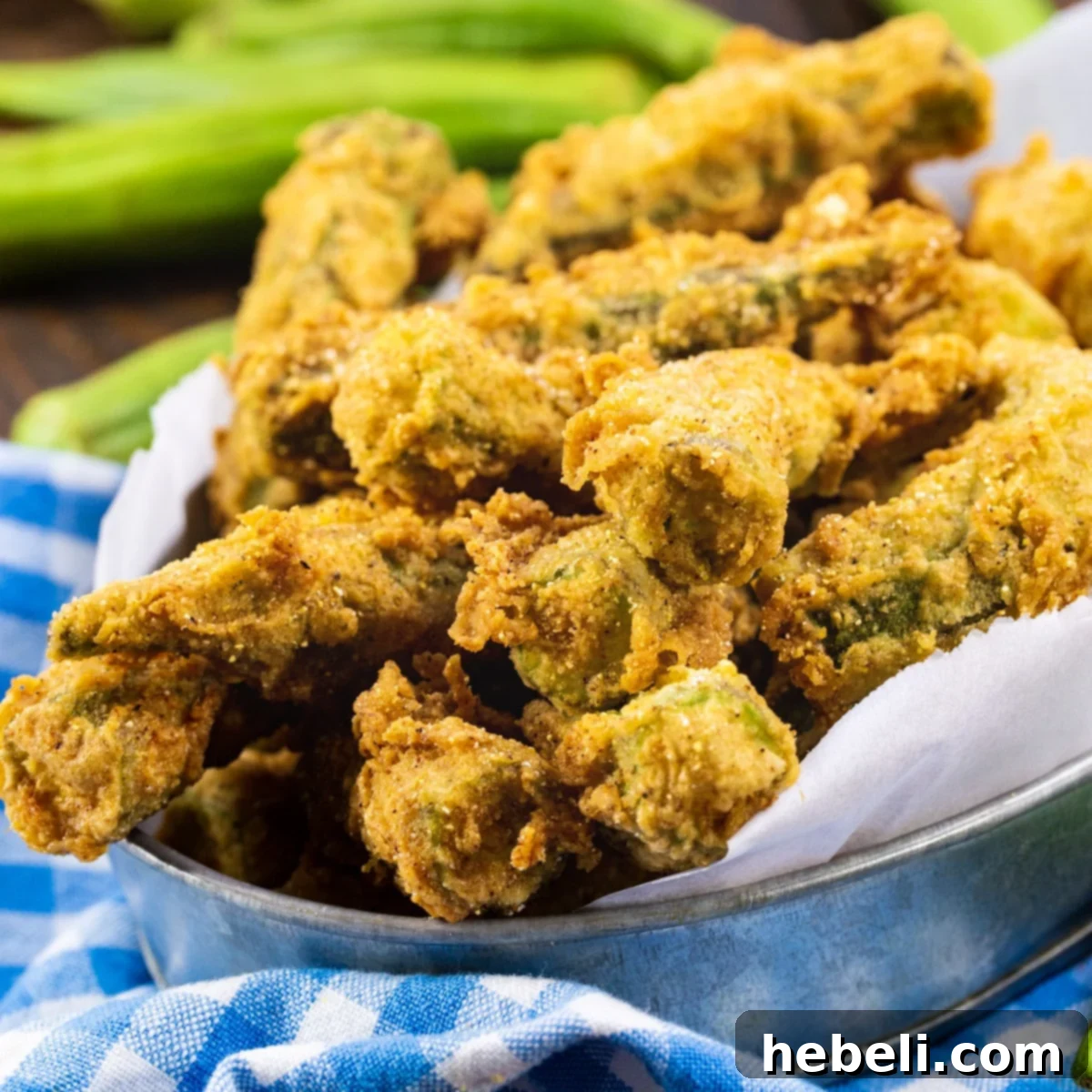 Whole Fried Okra in a metal tin, golden and crispy.