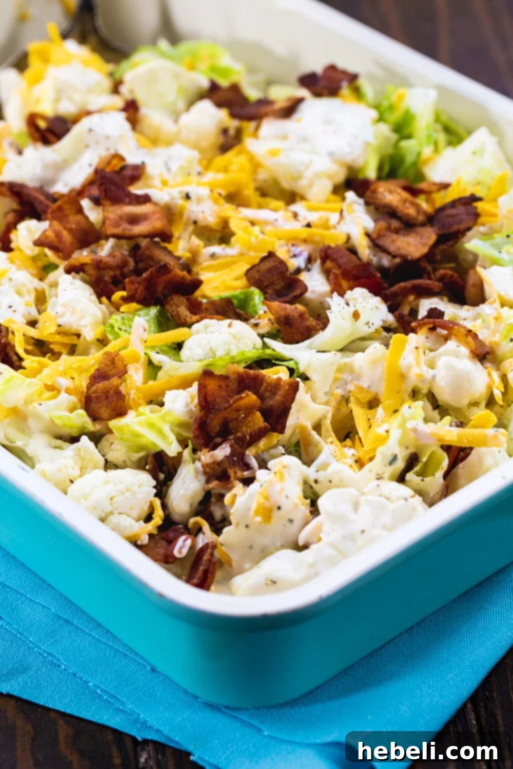 Creamy Bacon Ranch Cauliflower Crunch 4 Bacon and Ranch Cauliflower Salad in blue 9x13-inch pan, ready to be served.