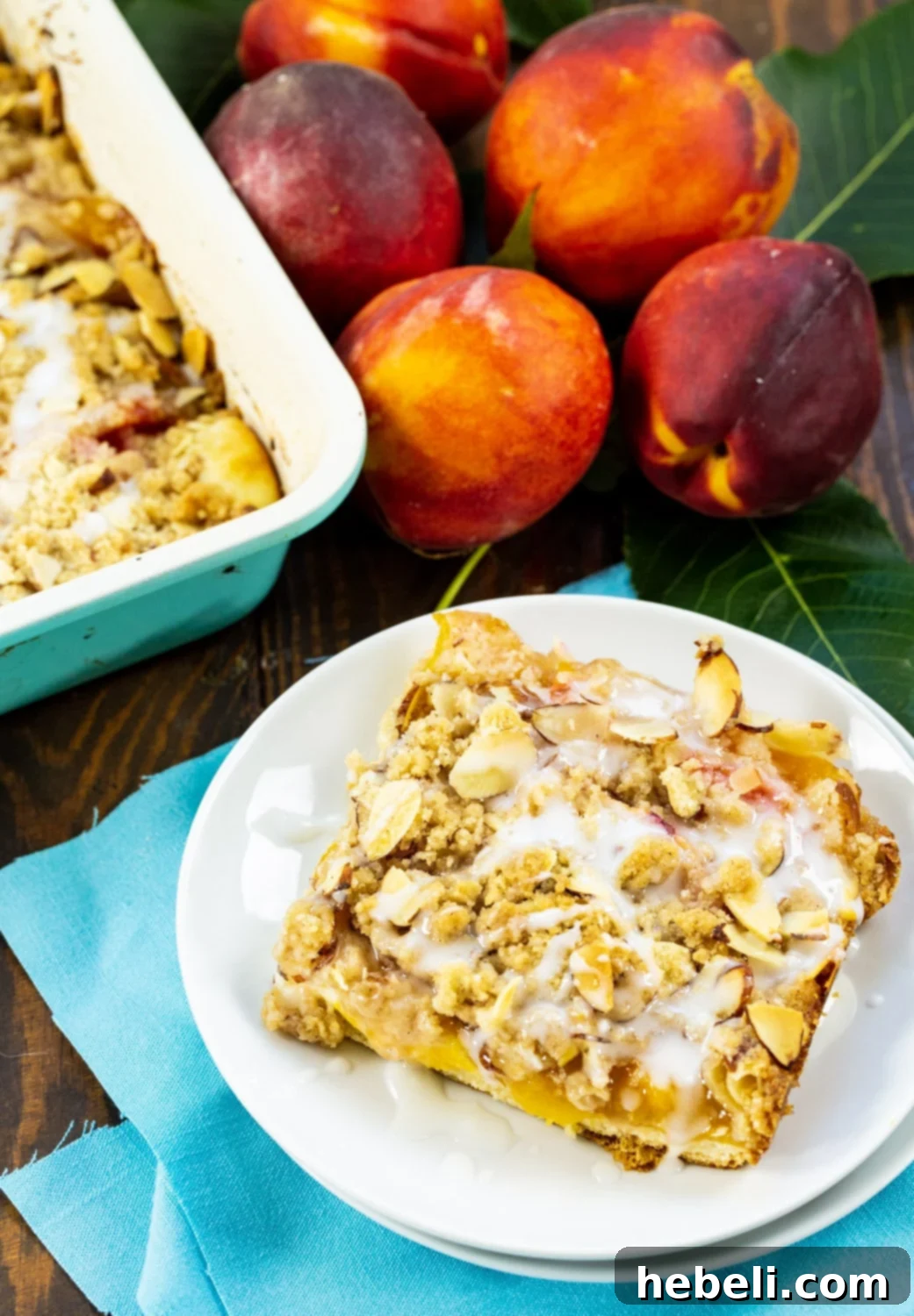 Luscious Peach Cream Crescent Bars 5 A close-up shot of a single Peaches and Cream Crescent Bar on a white plate, garnished with a mint leaf.