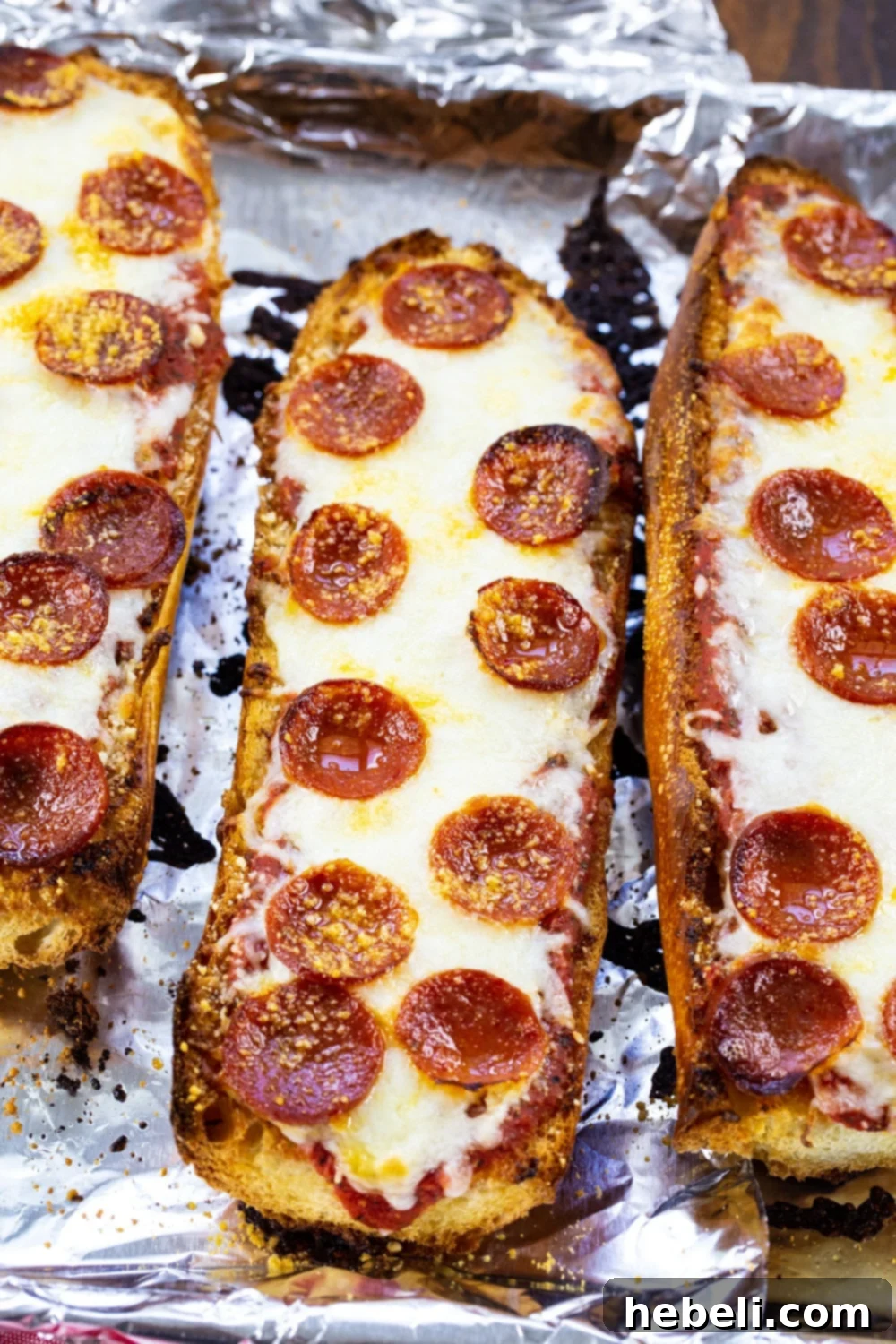Three pieces of French Bread Pizza topped with pepperoni, ready to be served.
