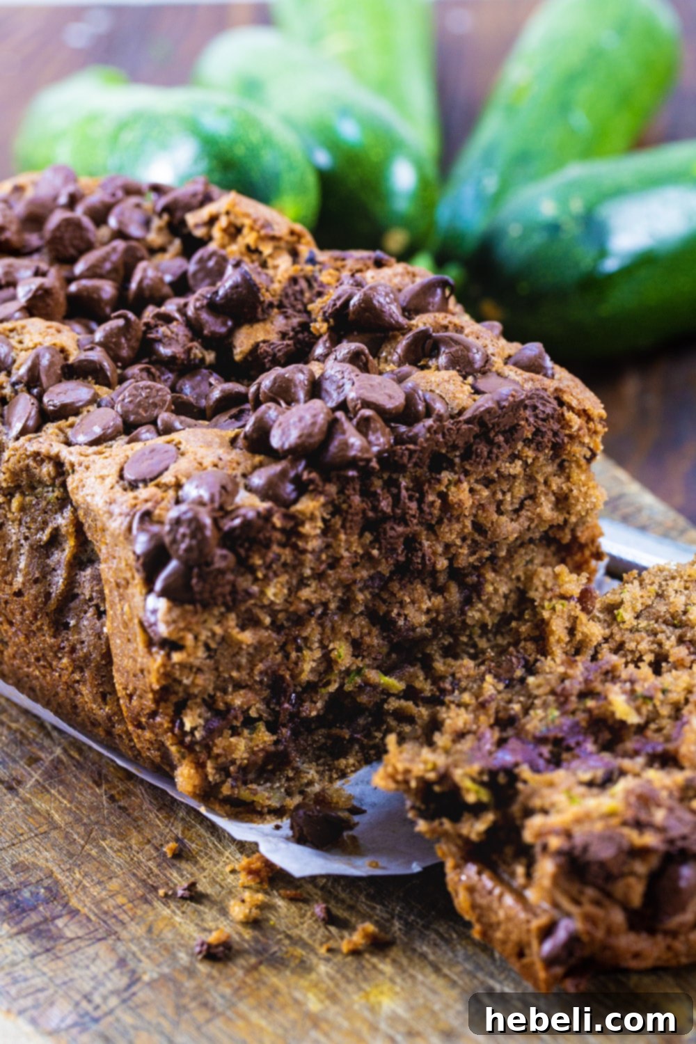 Decadent Chocolate Zucchini Loaf 4 A perfectly sliced piece of Chocolate Zucchini Bread, revealing its moist texture and chocolate chips.