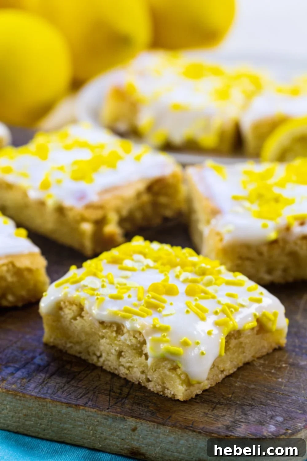 Lemon Cookie Bars topped with glaze and sprinkles.
