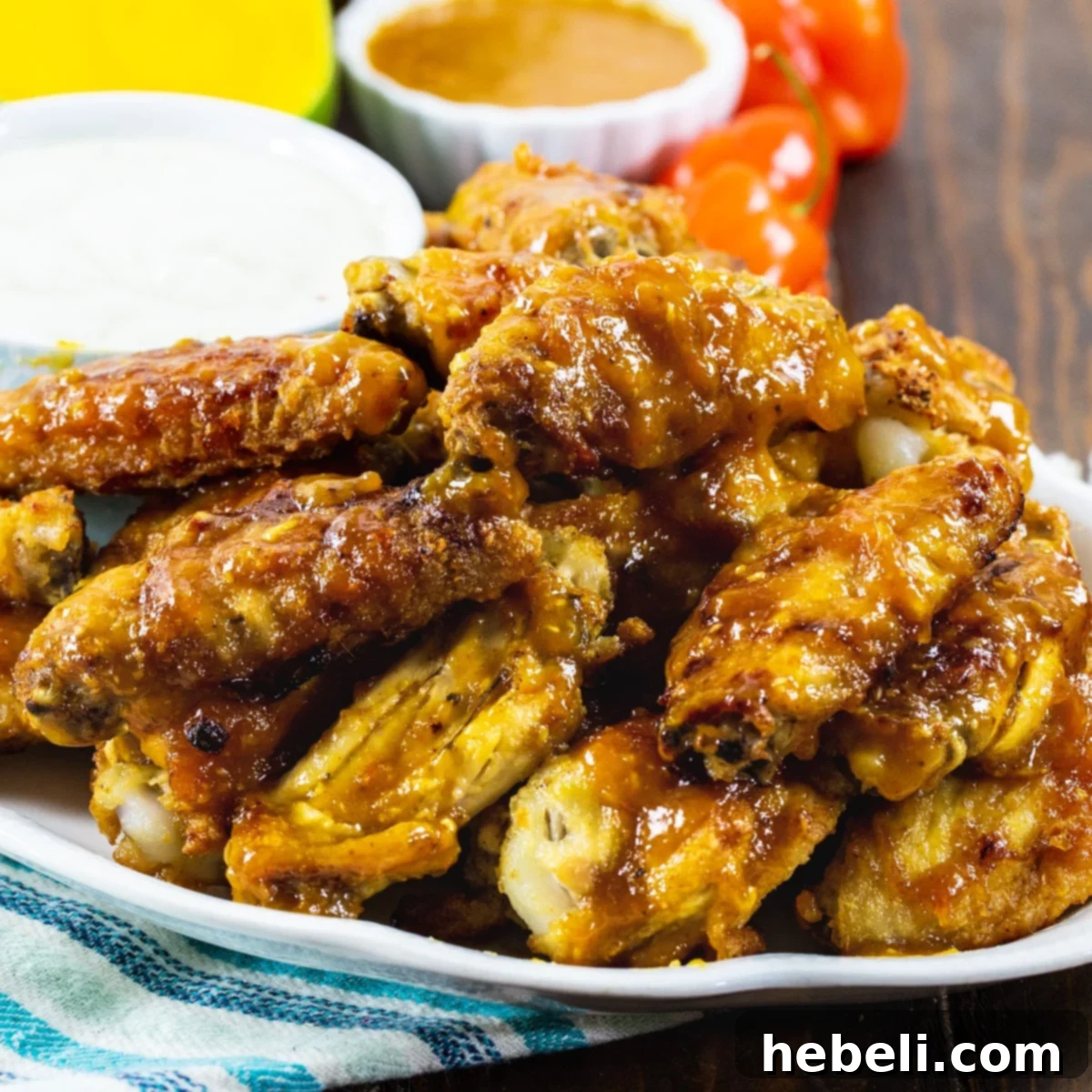 Sweet Heat Mango Habanero Wings 2 Golden-brown Mango Habanero Chicken Wings artfully arranged on a rustic plate, ready to be devoured.