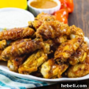 Mango Habanero Chicken Wings on a plate with a bowl of dressing.