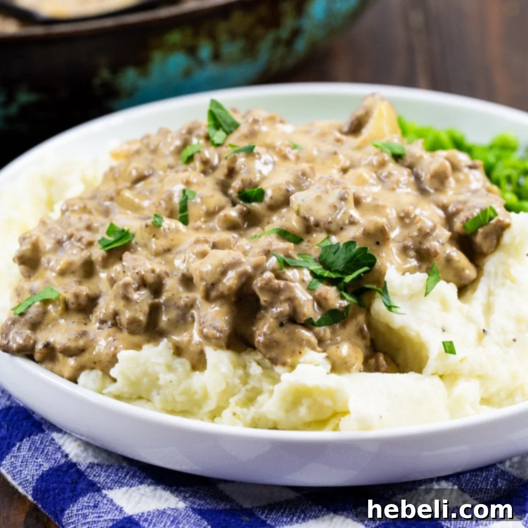 Easy Hamburger Gravy over creamy mashed potatoes, ready to be served for a comforting family meal.