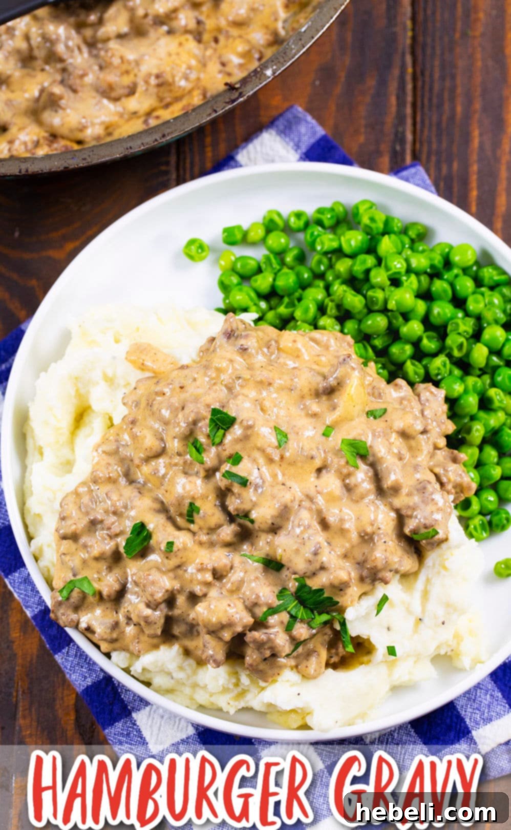 Easy Hamburger Gravy served over mashed potatoes with green peas, highlighting its comfort food appeal.