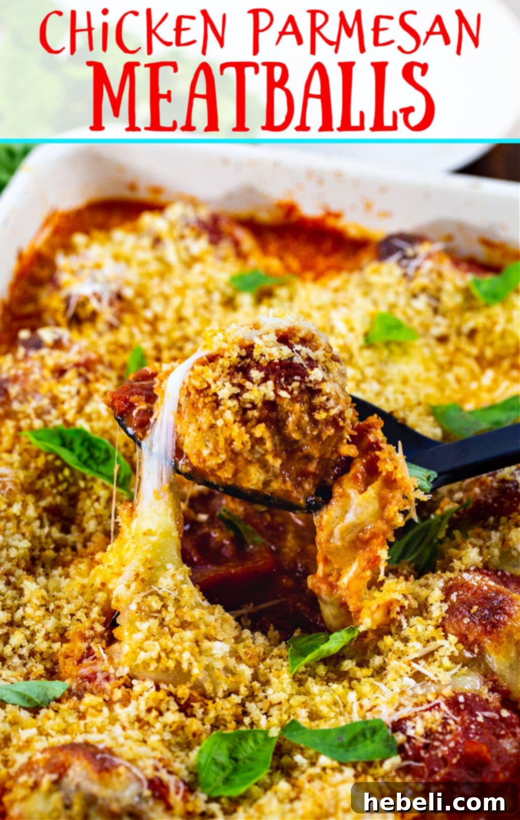 Close-up of baked Chicken Parmesan Meatballs with melted cheese and fresh basil, ready to be served.