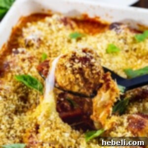Chicken Parmesan Meatballs in a baking dish, garnished with fresh basil, ready for serving.
