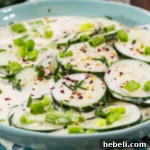 Creamy Spicy Cucumbers in a blue bowl.