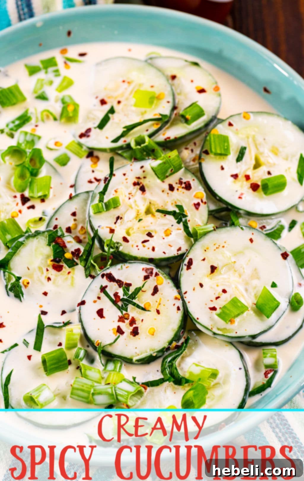 Beautifully prepared Creamy Spicy Cucumbers in a blue bowl, garnished with fresh herbs, showcasing the dish's appeal as a perfect summer accompaniment.