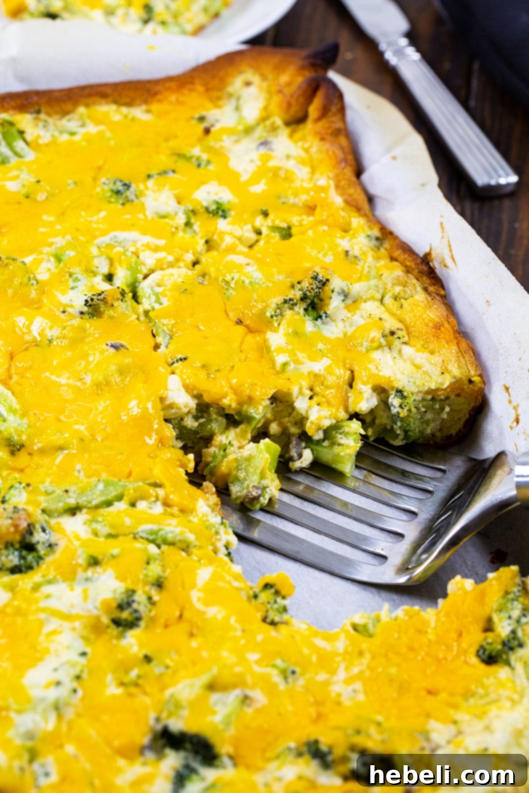 Broccoli Crescent Squares with one piece removed, showing the layers of dough and cheesy filling.