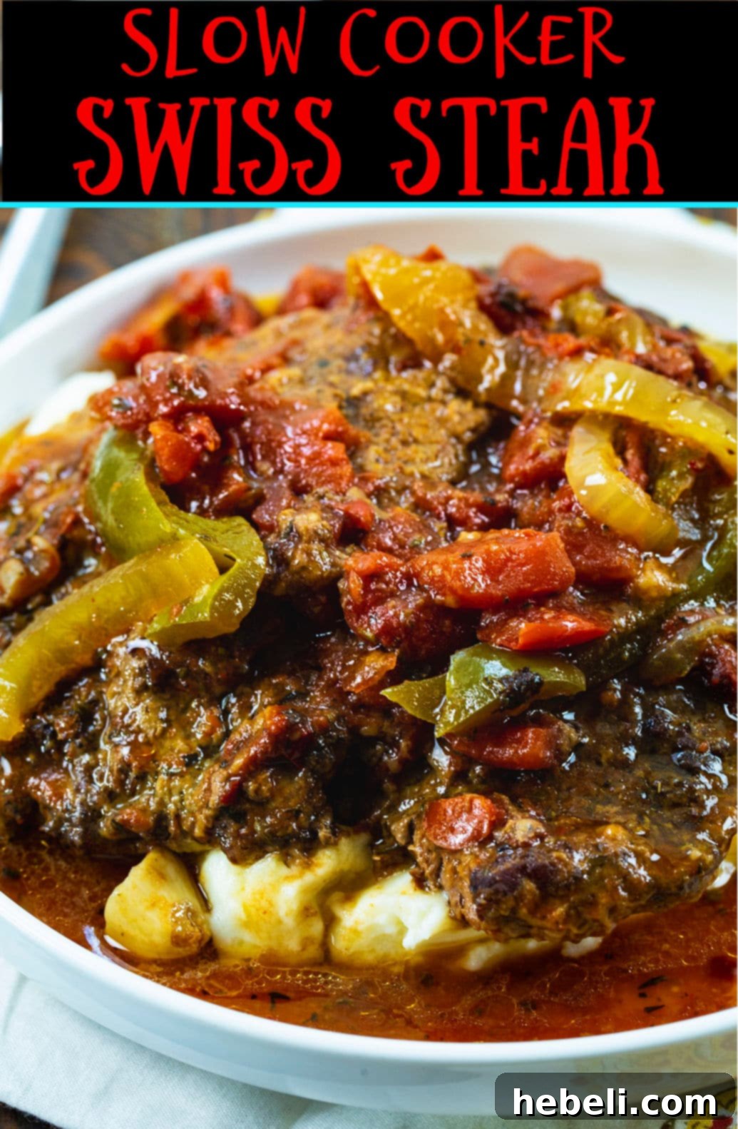 Tender Slow Cooker Swiss Steak 5 Close-up of Slow Cooker Swiss Steak, showcasing its tender texture and the rich, glossy tomato sauce.