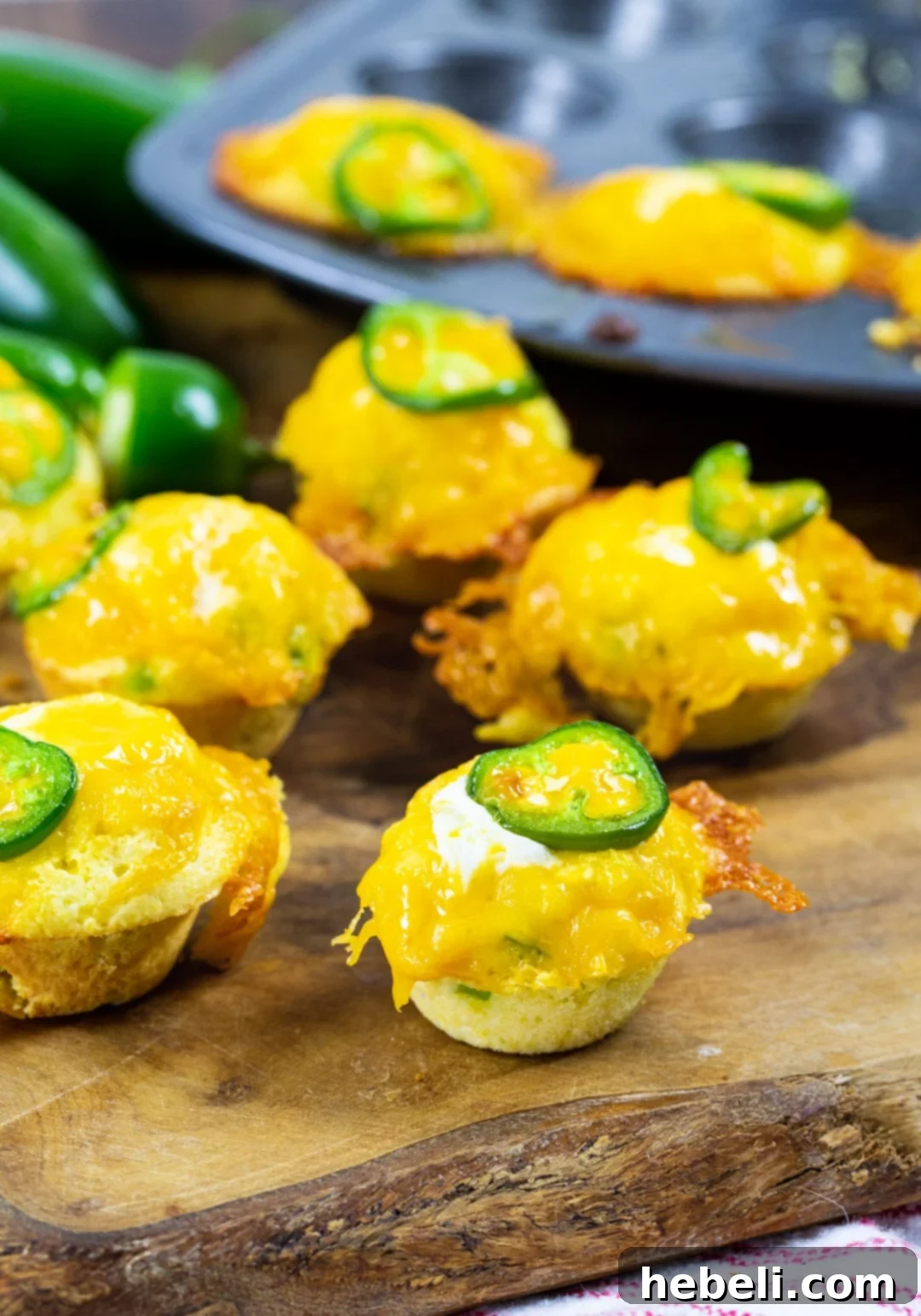 Jalapeno Cornbread Poppers 3 Corn Muffins on wood serving board.