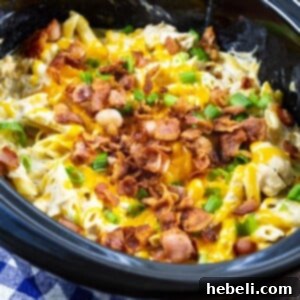 Slow Cooker Crack Chicken Pasta cooking in a crock pot.